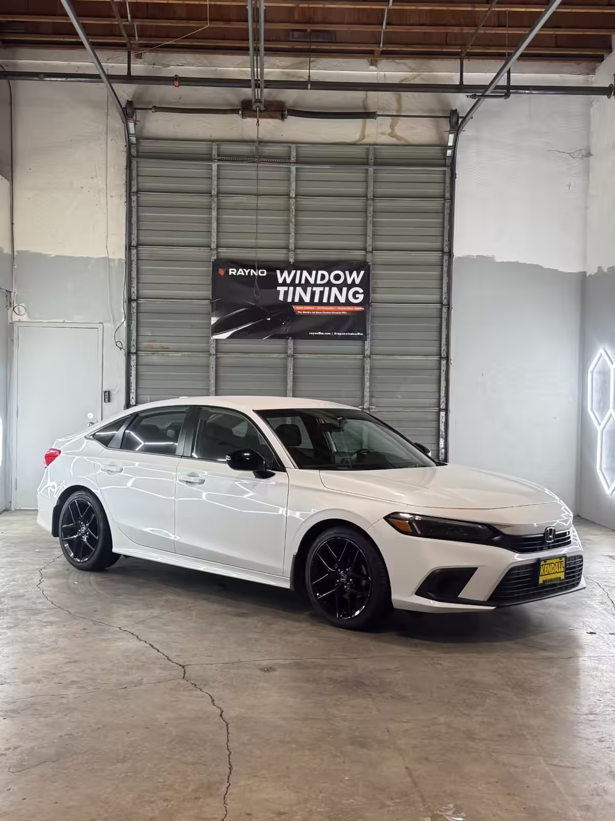 White Honda sedan after window tint service